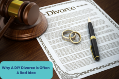 a gavel, divorce papaers, and wedding rings