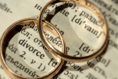 two wedding rings on top of the word divorce