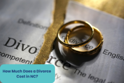 divorce word with a pair of wedding rings on a table