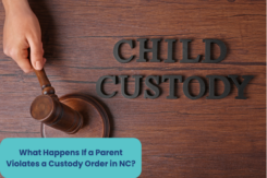 a hand holding a gavel and a "CHILD CUSTODY" on a wooden background